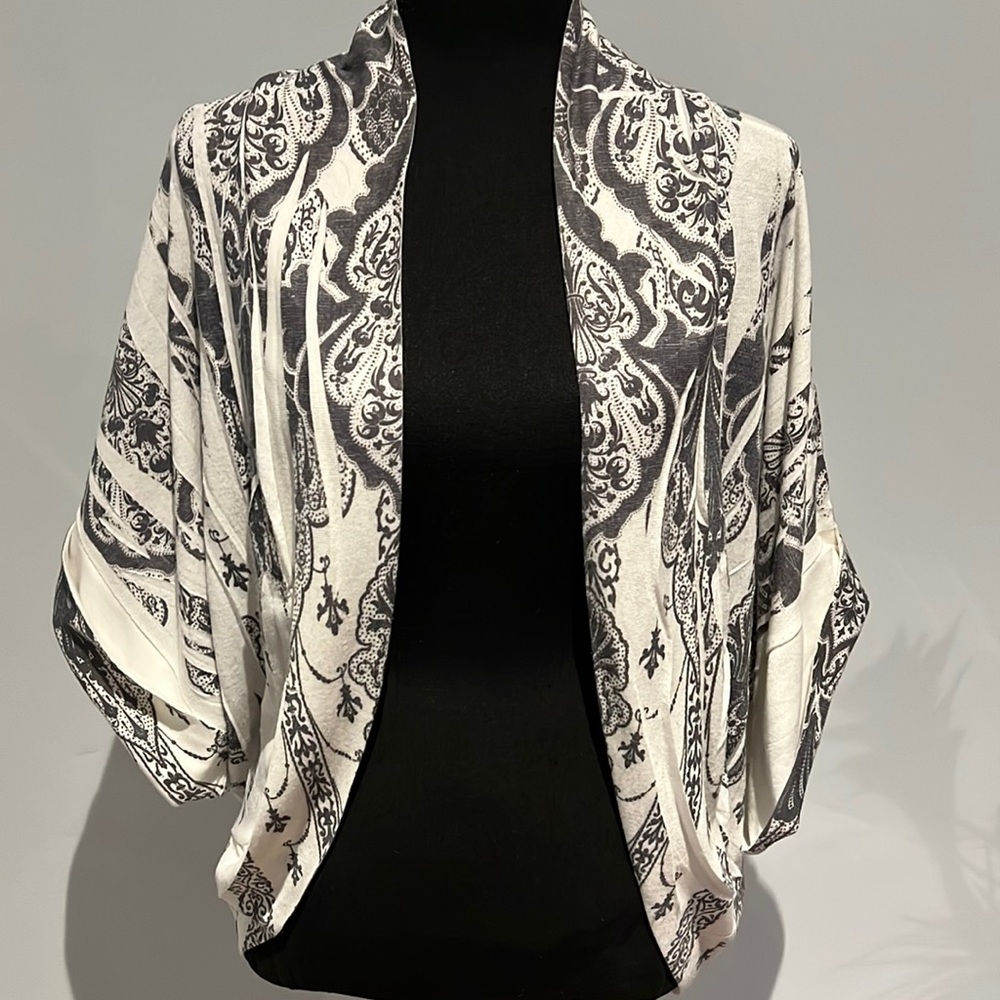 “Shrug” sweater with intricate design